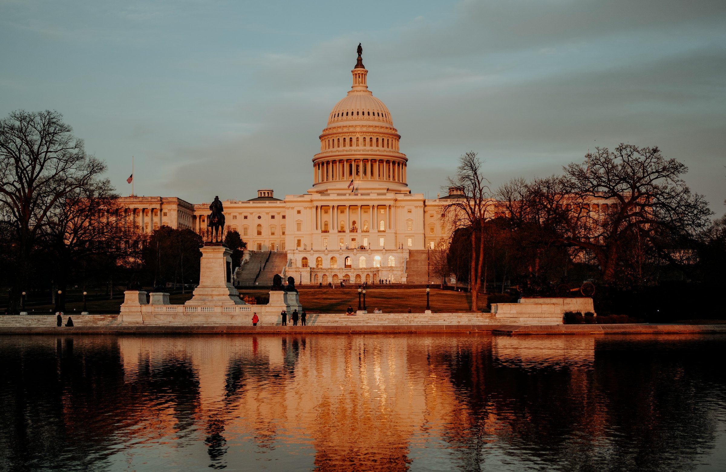 The U.S. Capitol at sunset over the reflecting pool